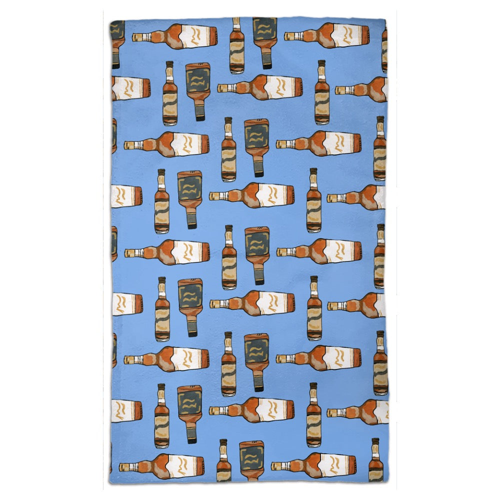 Tea towel hand designed by Jessica Reynolds art. Featuring bourbon bottles on a microfiber towel with a terry loop back.