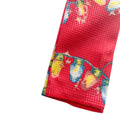 Red towelwith colorful christmas light patterns on a white surface