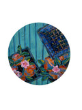 Decorative plate with floral design on a white wall