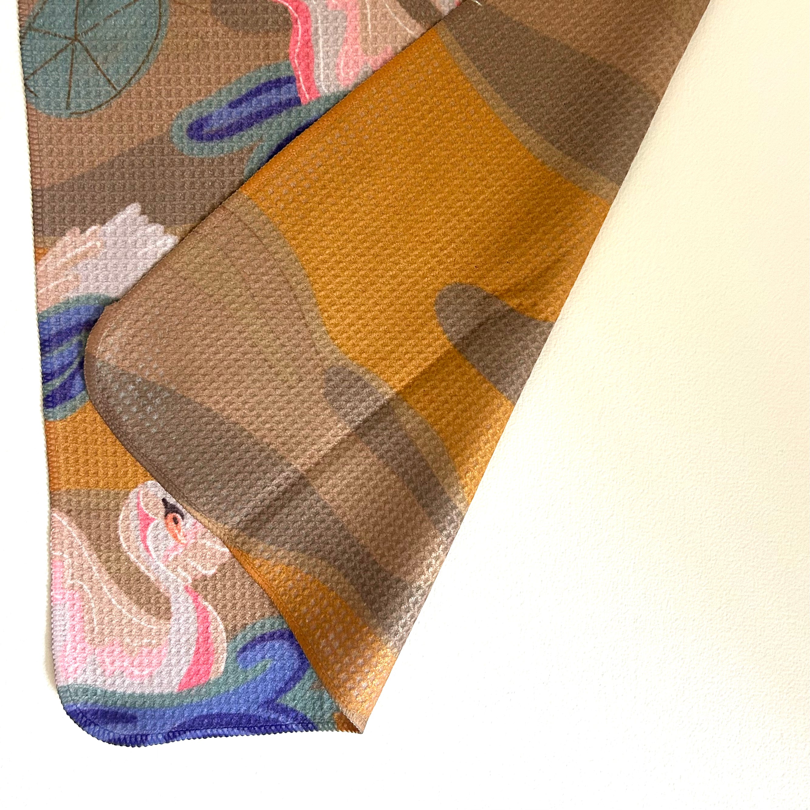Close-up of a patterned fabric with swan design on a white background