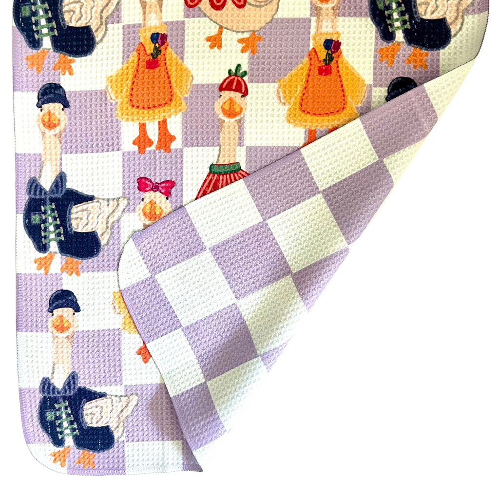 Checkered towel with porch geese design on a white background