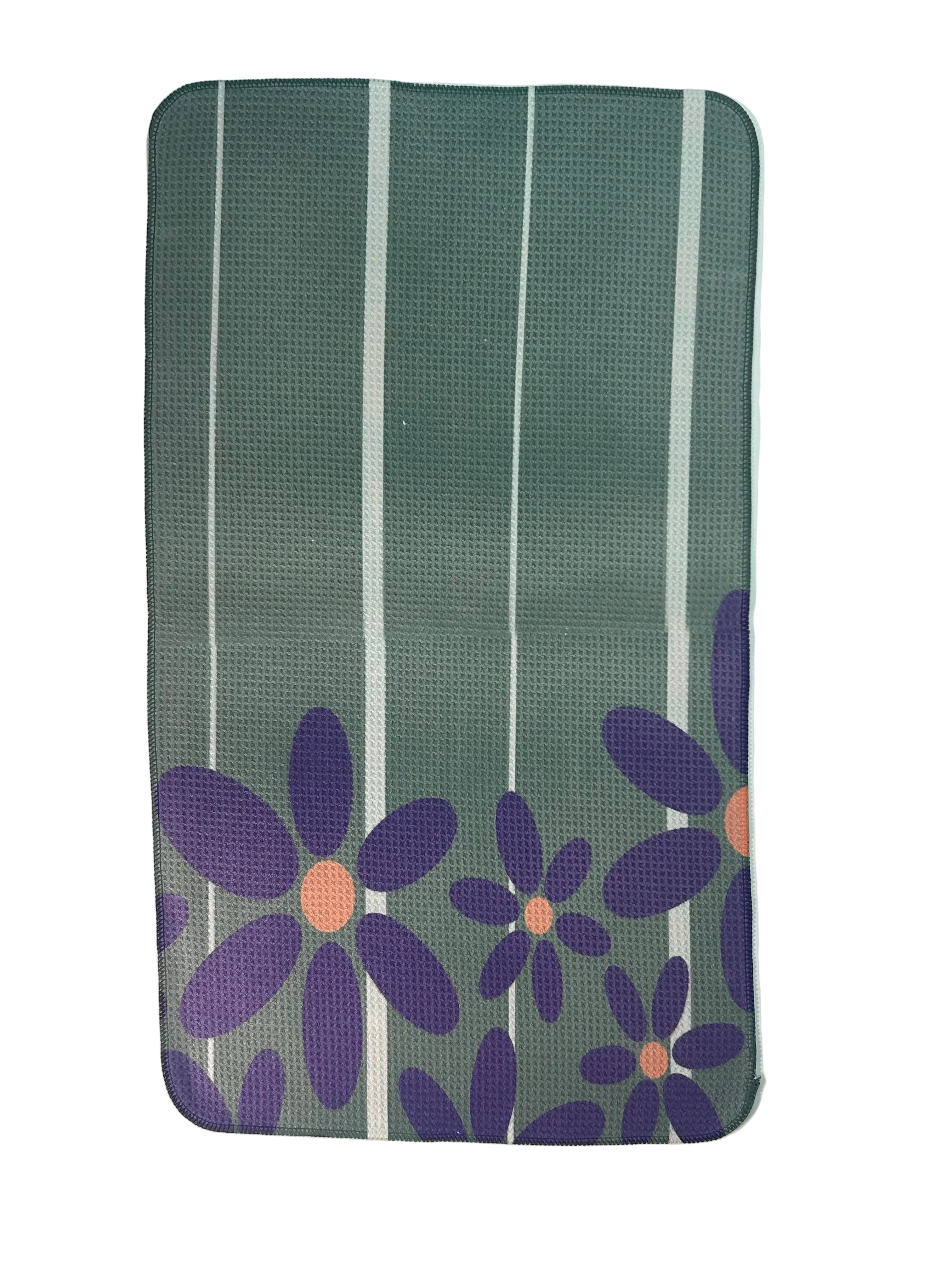 Floral-patterned towel with purple flowers and green background on a white background