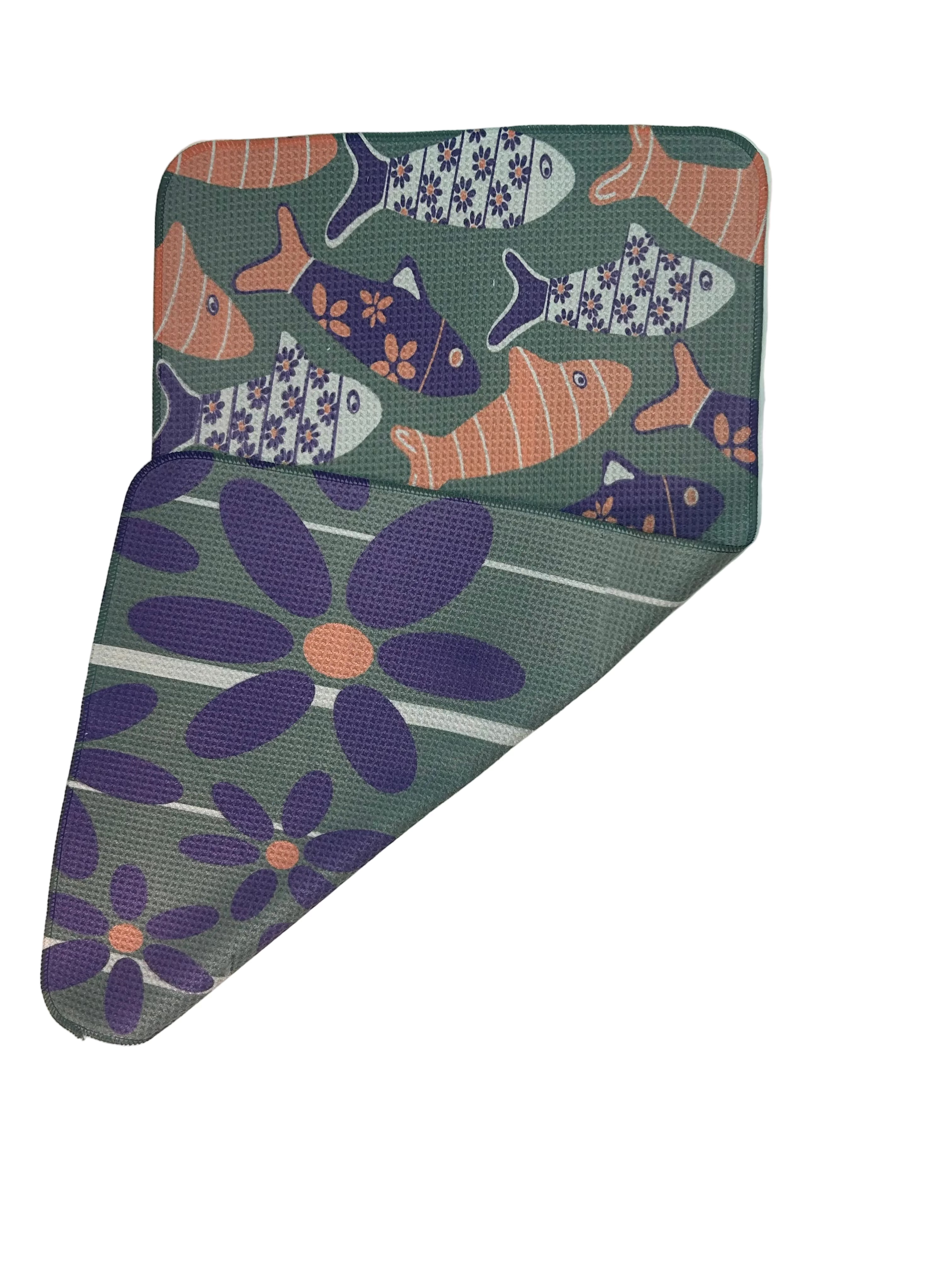 Tea towel with fish and flower pattern on a green background