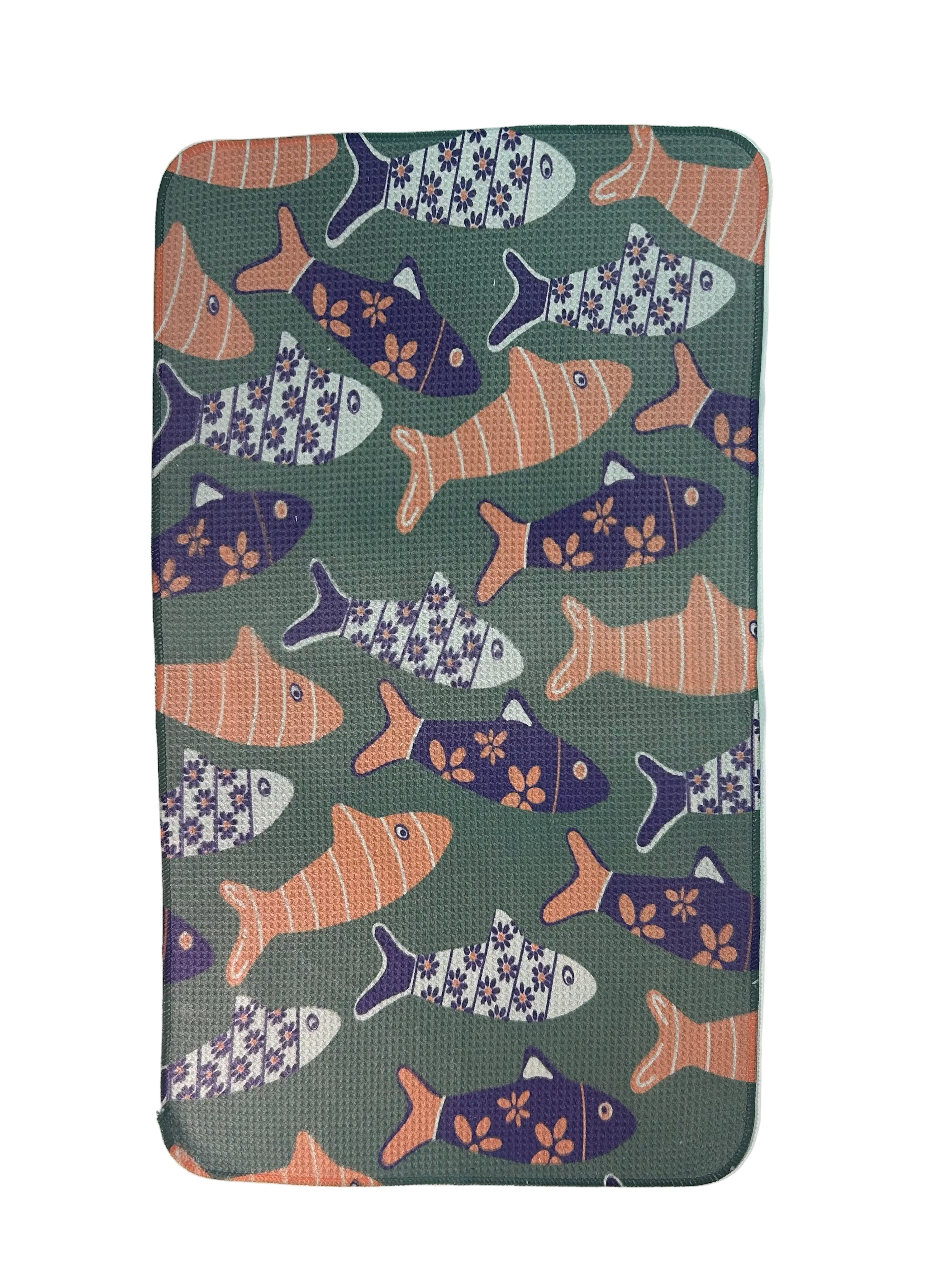 Patterned tea towel with fish design on a green background