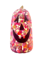 Tall pink and gold pumpkin on white background