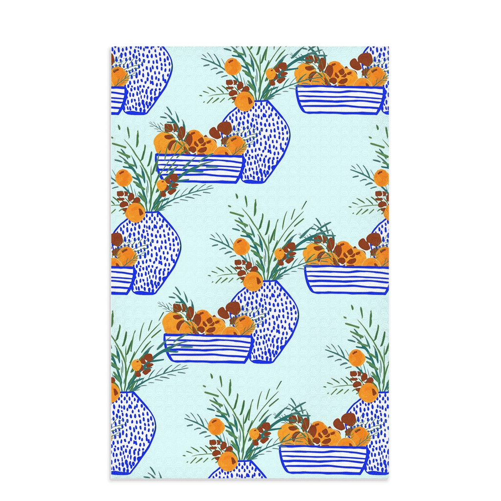 Tea towel hand designed by Jessica Reynolds with citrus and greenery in blue and white vases on a waffle  microfiber towel.