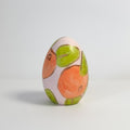 Hand painted ceramic easter eggs featuring oranges.