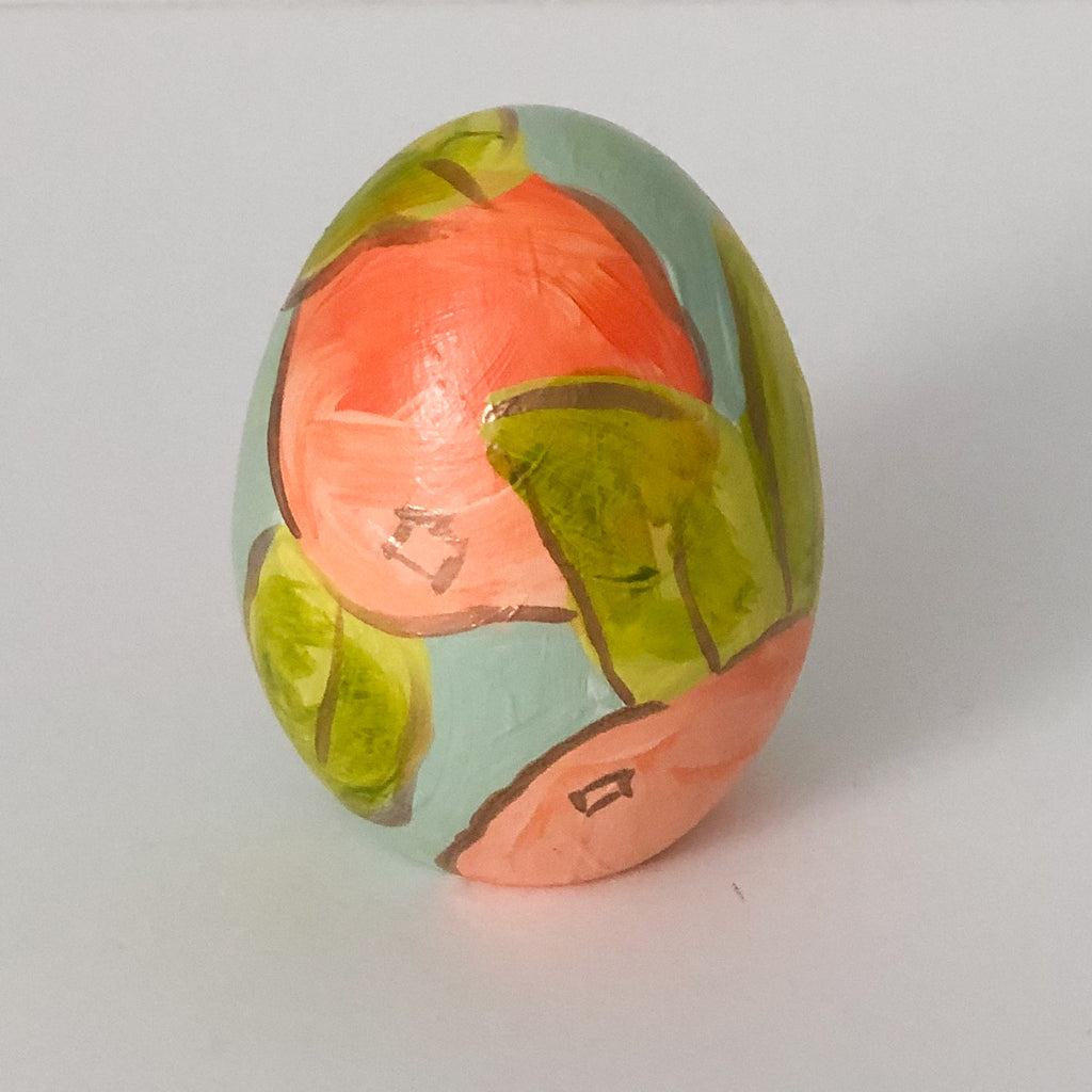 Hand painted ceramic easter eggs featuring oranges.