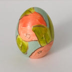 Hand painted ceramic easter eggs featuring oranges.