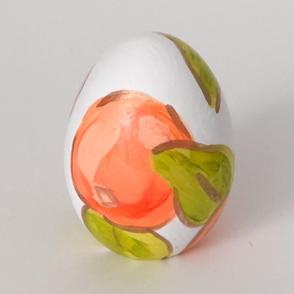 Hand painted ceramic easter eggs featuring oranges.