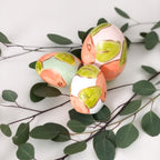 Hand painted ceramic easter eggs featuring oranges.