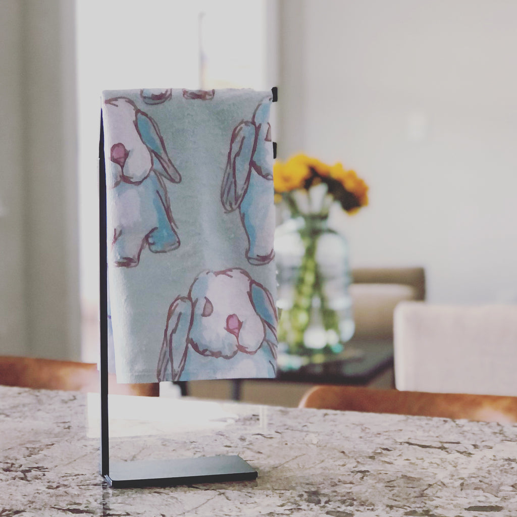 Tea towel hand designed by Jessica Reynolds art. Featuring water color bunnies on a microfiber towel with a terri loop backing.
